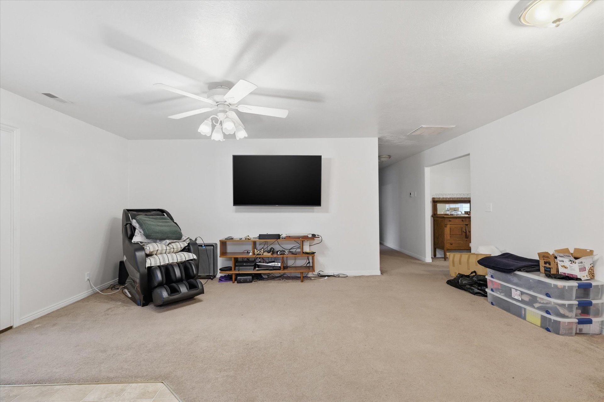 Spacious living room with vaulted ceiling and ceiling fan