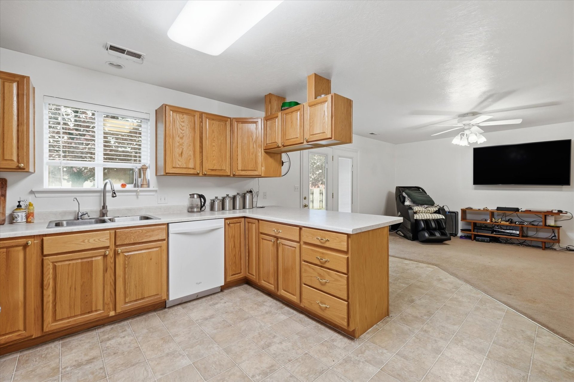 Open kitchen flowing into the great room with backyard access