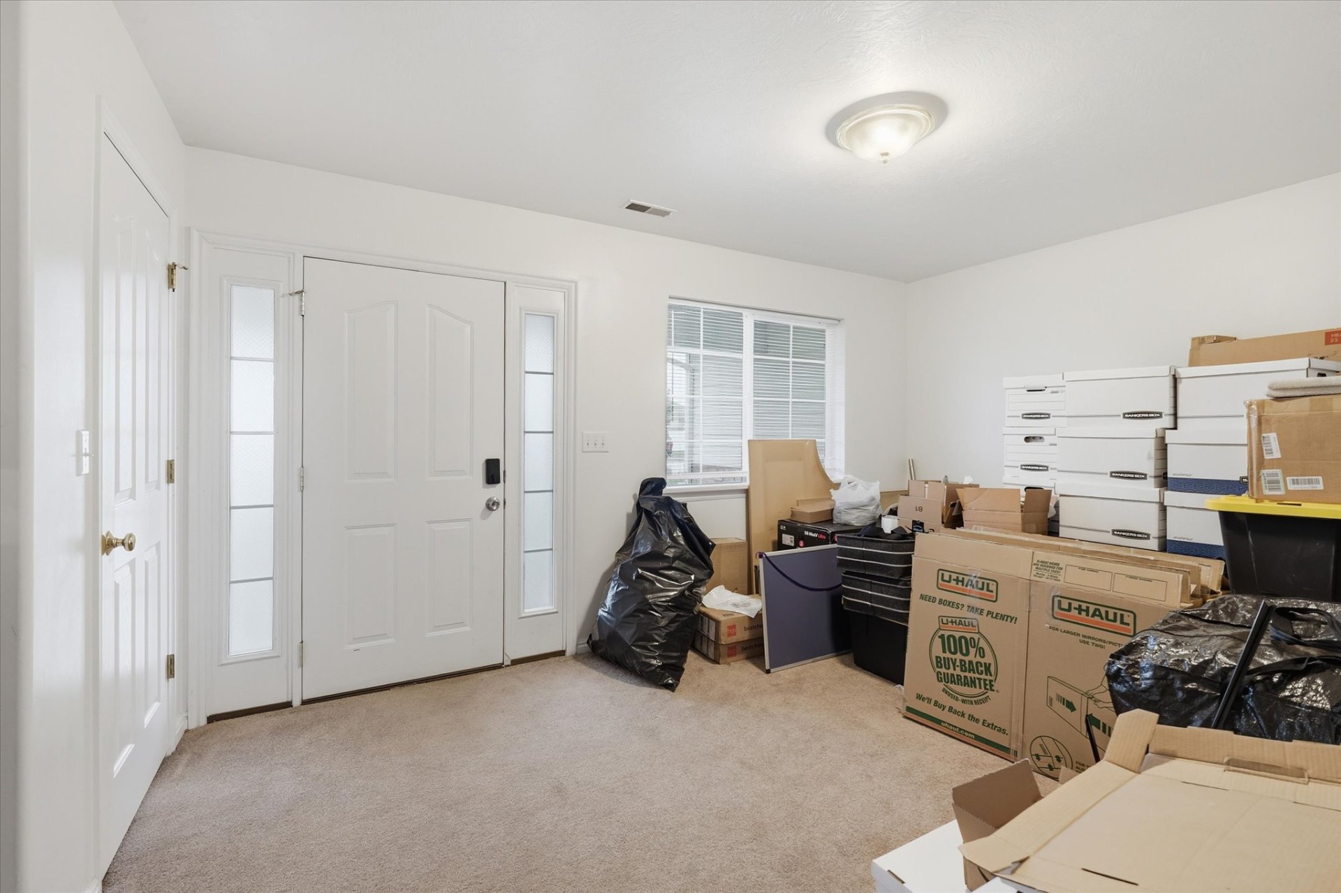 Welcoming front entry with sidelight windows and bright foyer